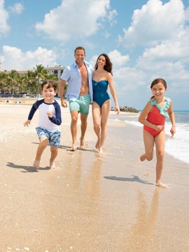 Family-running-along-the-beach-at-The-Breakers-Palm-Beach-one-of-the-best-beach-resorts-for-families-in-Florida.